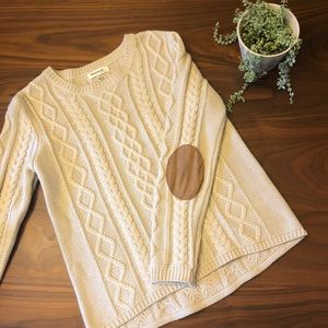 Cream cable knit sweater with suede elbow patches